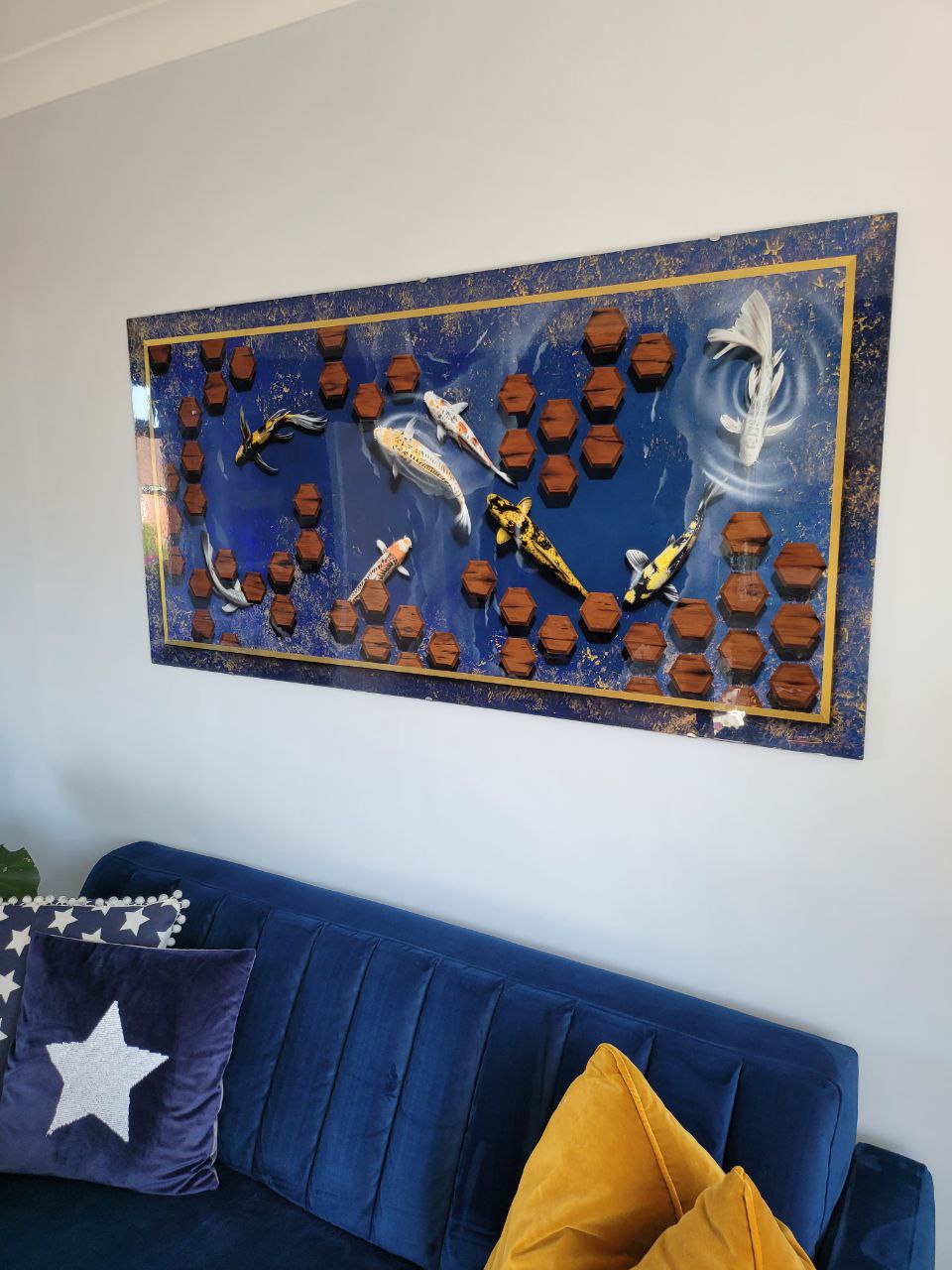 Airbrushed Painting of Koi Fish on Blue Background mounted on a wall